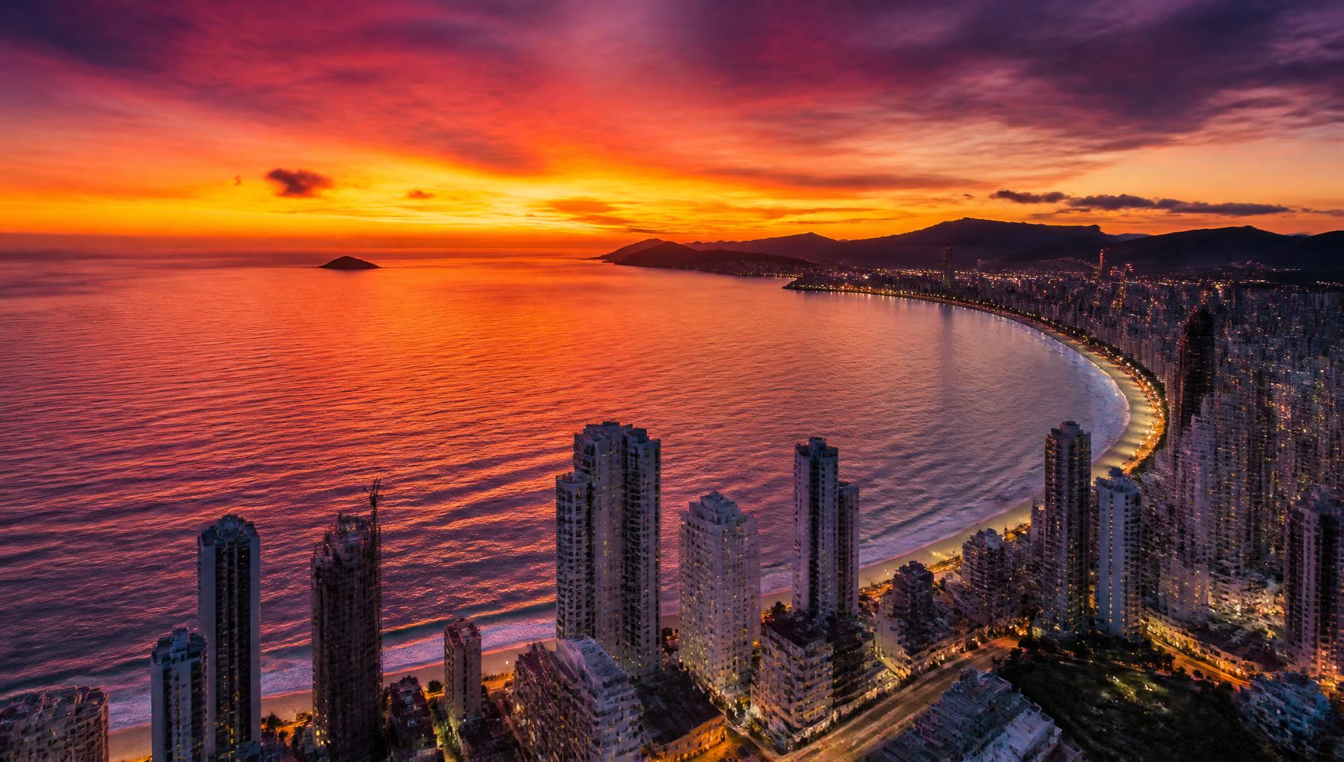 Vista aérea de Balneário Camboriú ao pôr do sol com a orla iluminada